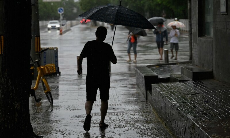 Tens of thousands evacuated as northern China hit by torrential rain .